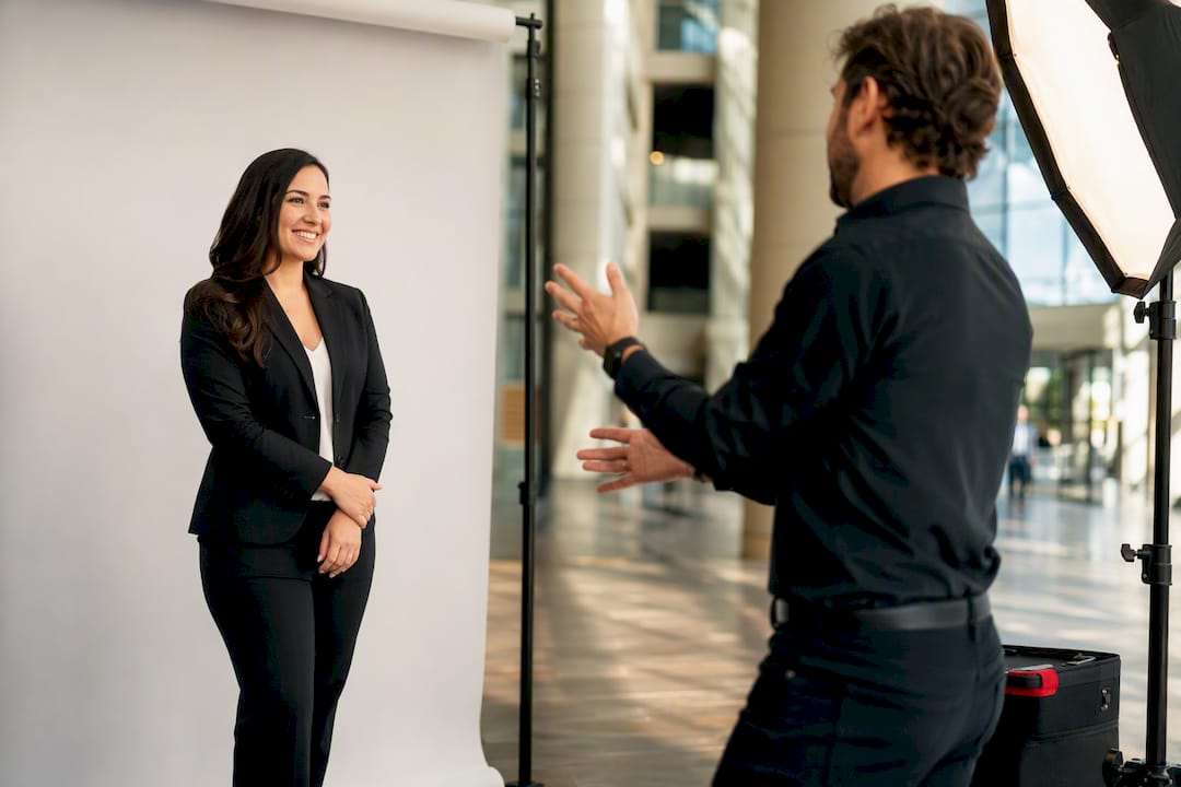 Photographer directing trade show headshot session