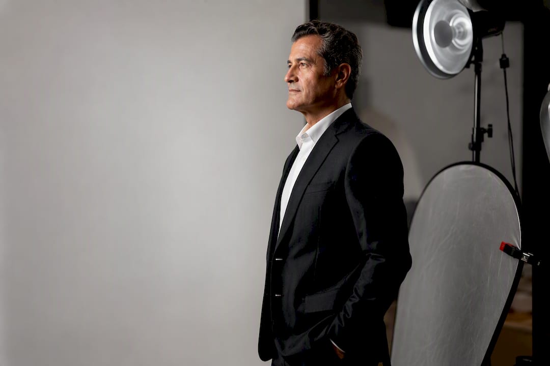 Executive posing for monochrome studio headshot