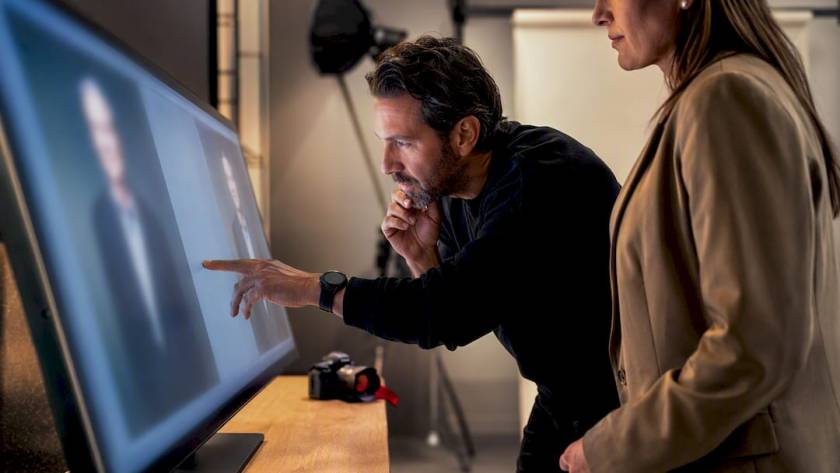 Executive reviewing headshot on large monitor