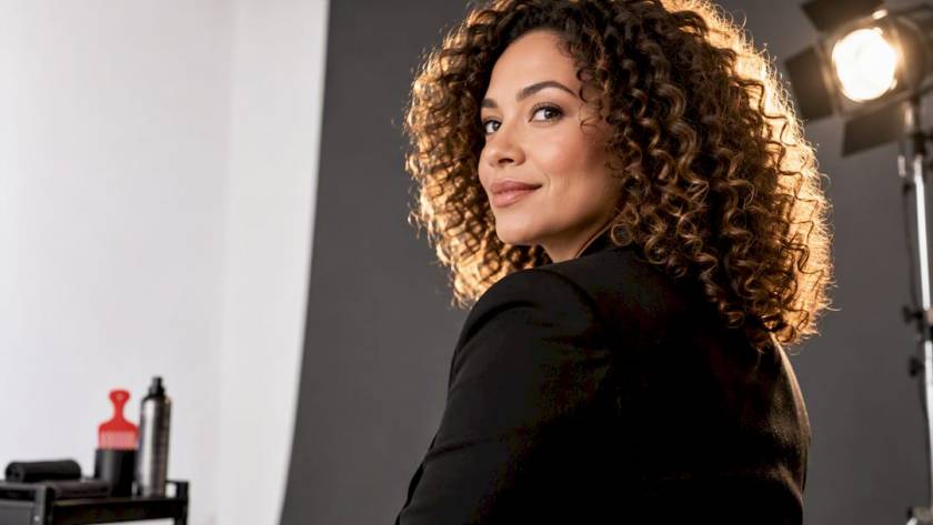 Curly-haired executive with defined backlit curls